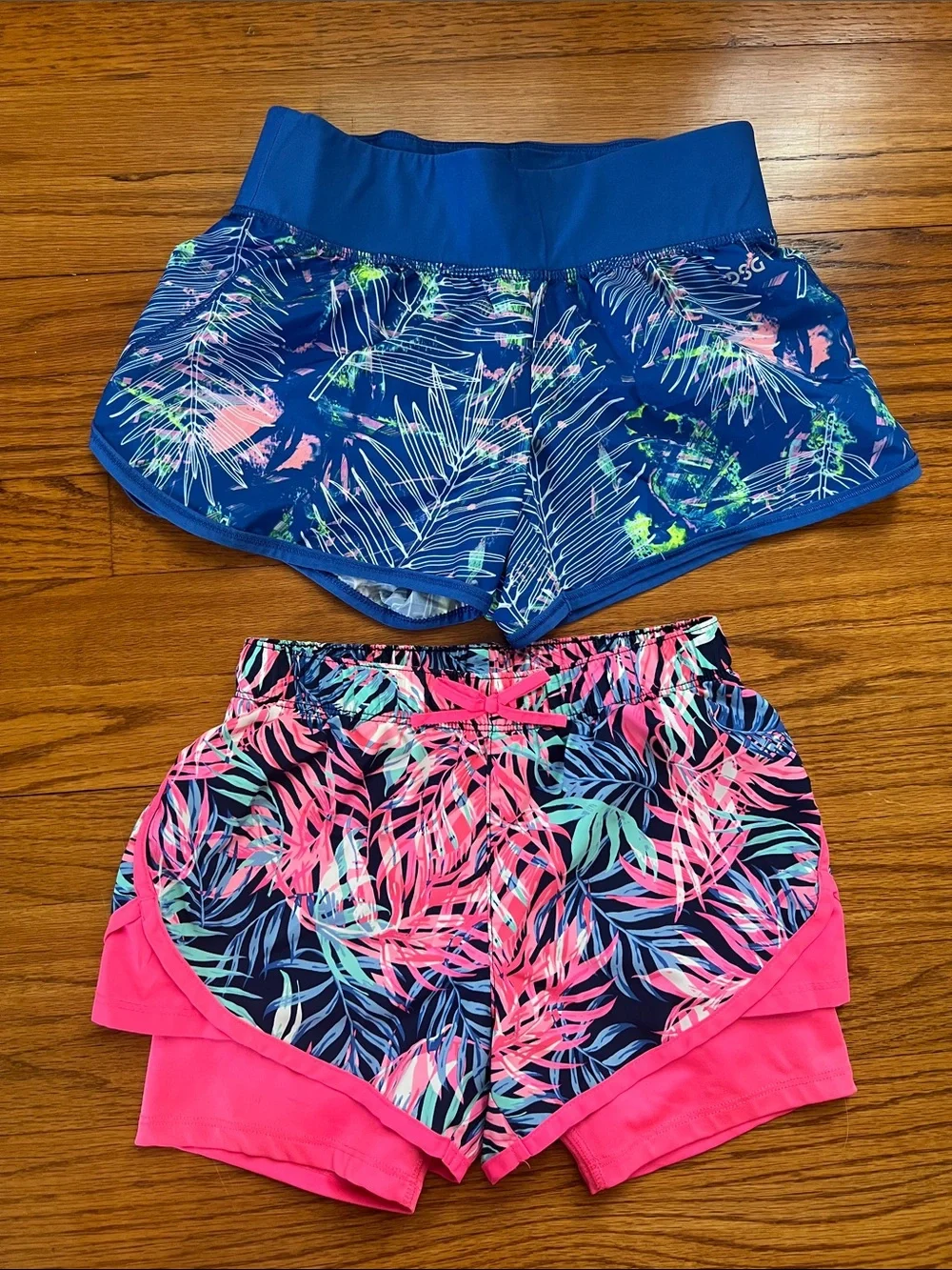 2-pack girls size small athletic shorts. 1. DSG blue pattern, 2. Oshkosh pink